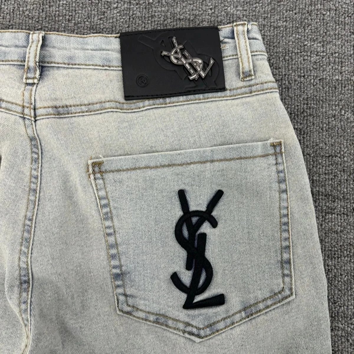 Saint Laurent Light Wash Denim Jeans with YSL Logo Patch